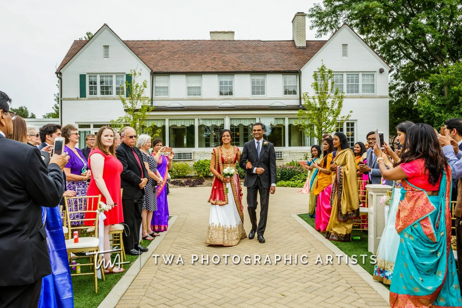 Bride and groom with their bridal party in front of the iconic Danada House.