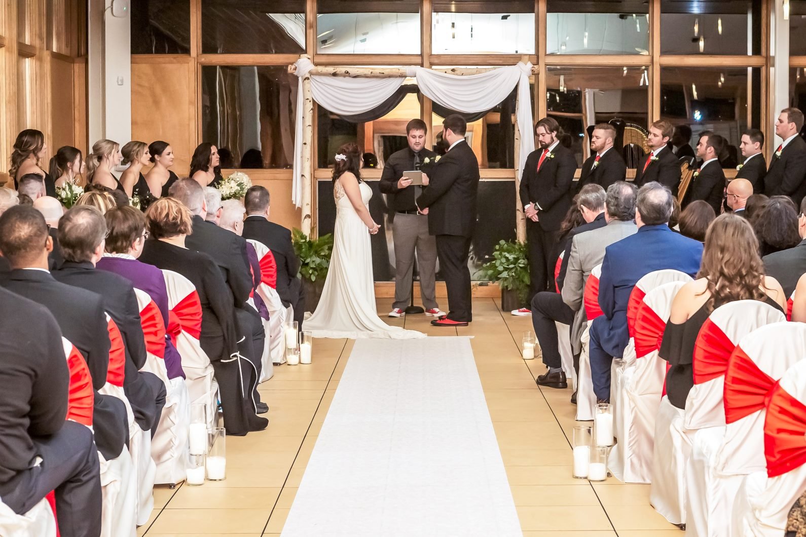 A wedding ceremony in the atrium at danada house with a big wedding party