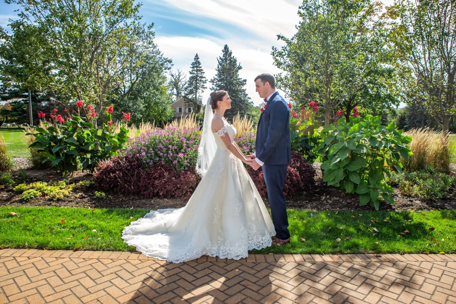 A man and woman in a wedding dress in the rose garden at danada house