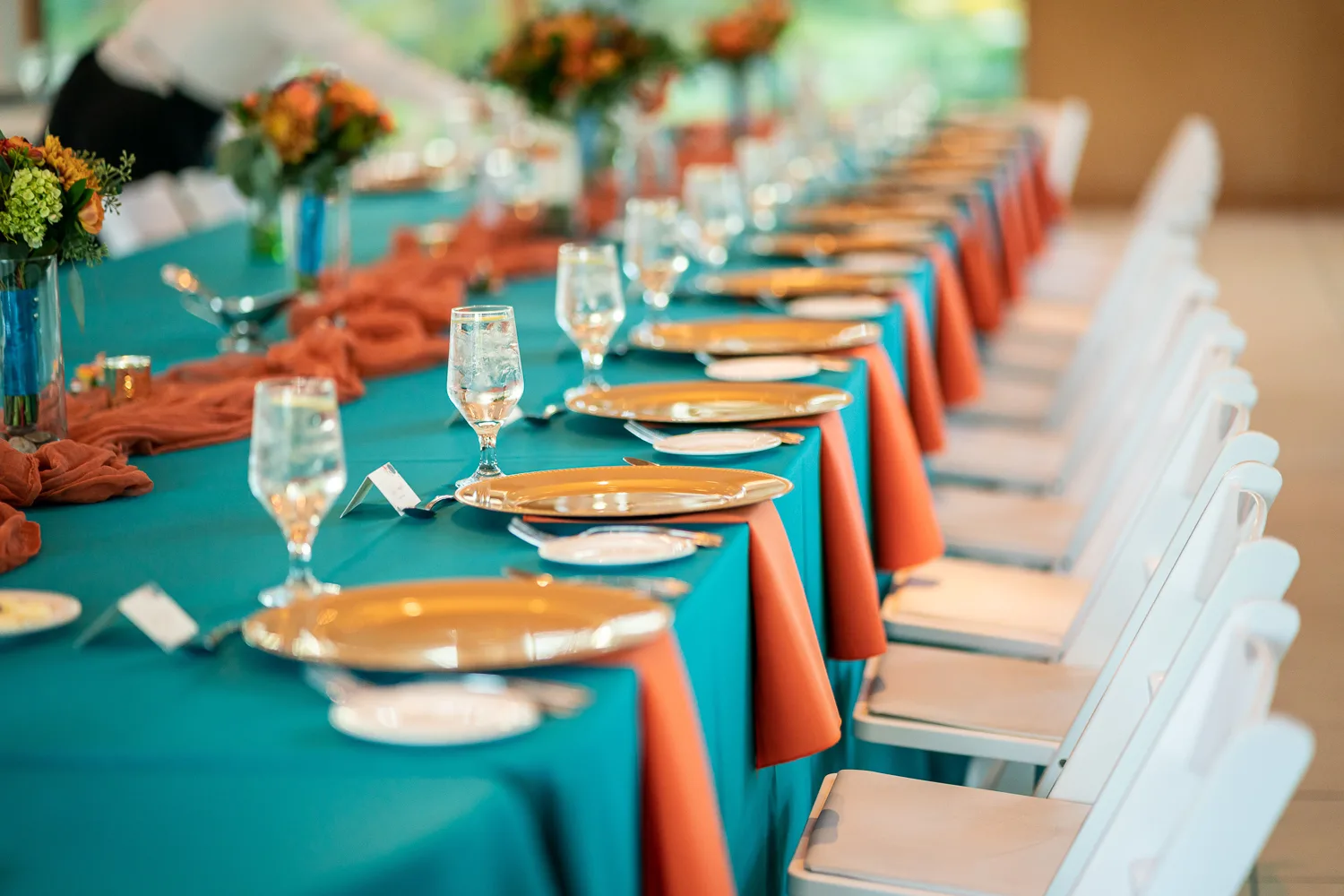 A long table with plates and glasses on it