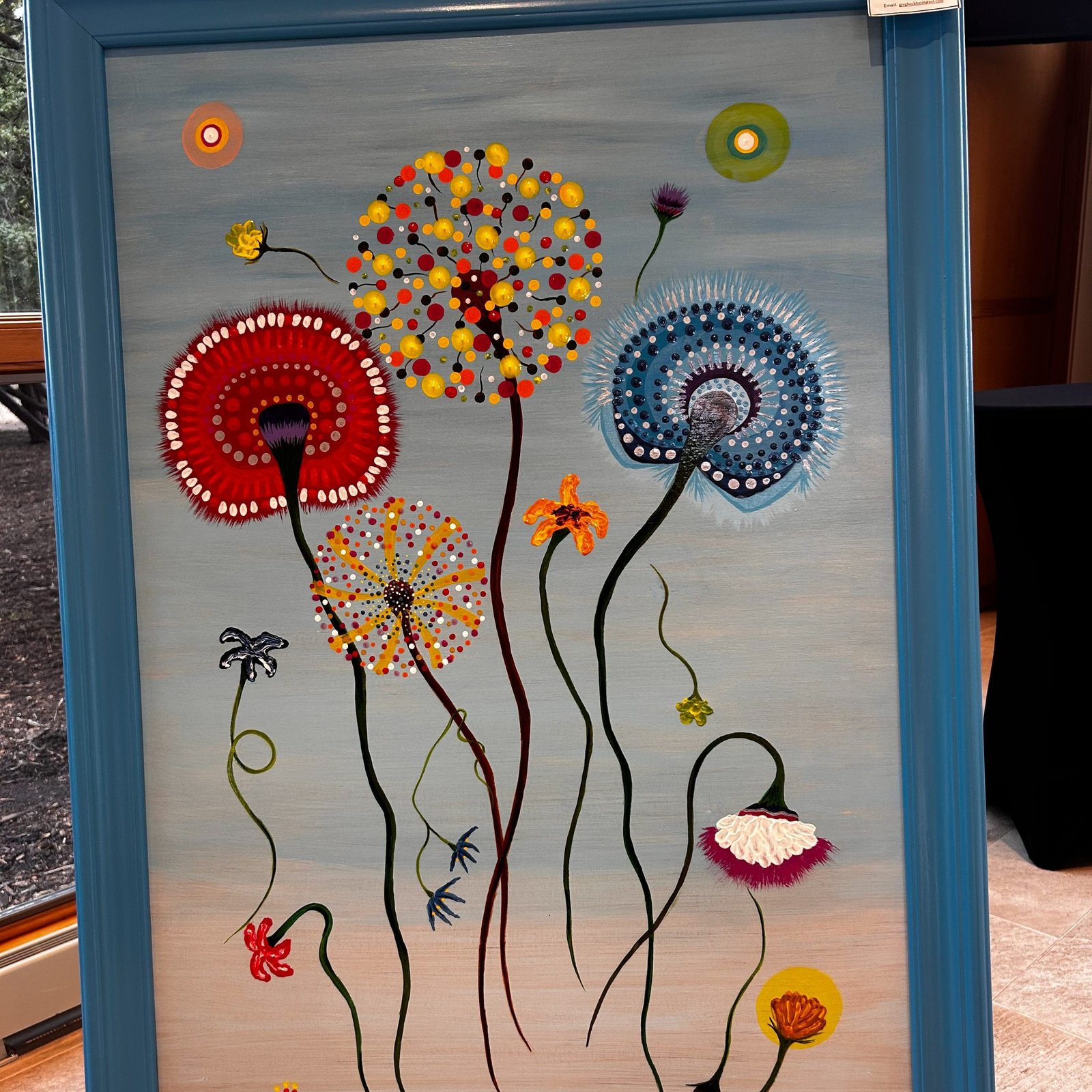 Colorful stylized dandelion flower painting on display at the show