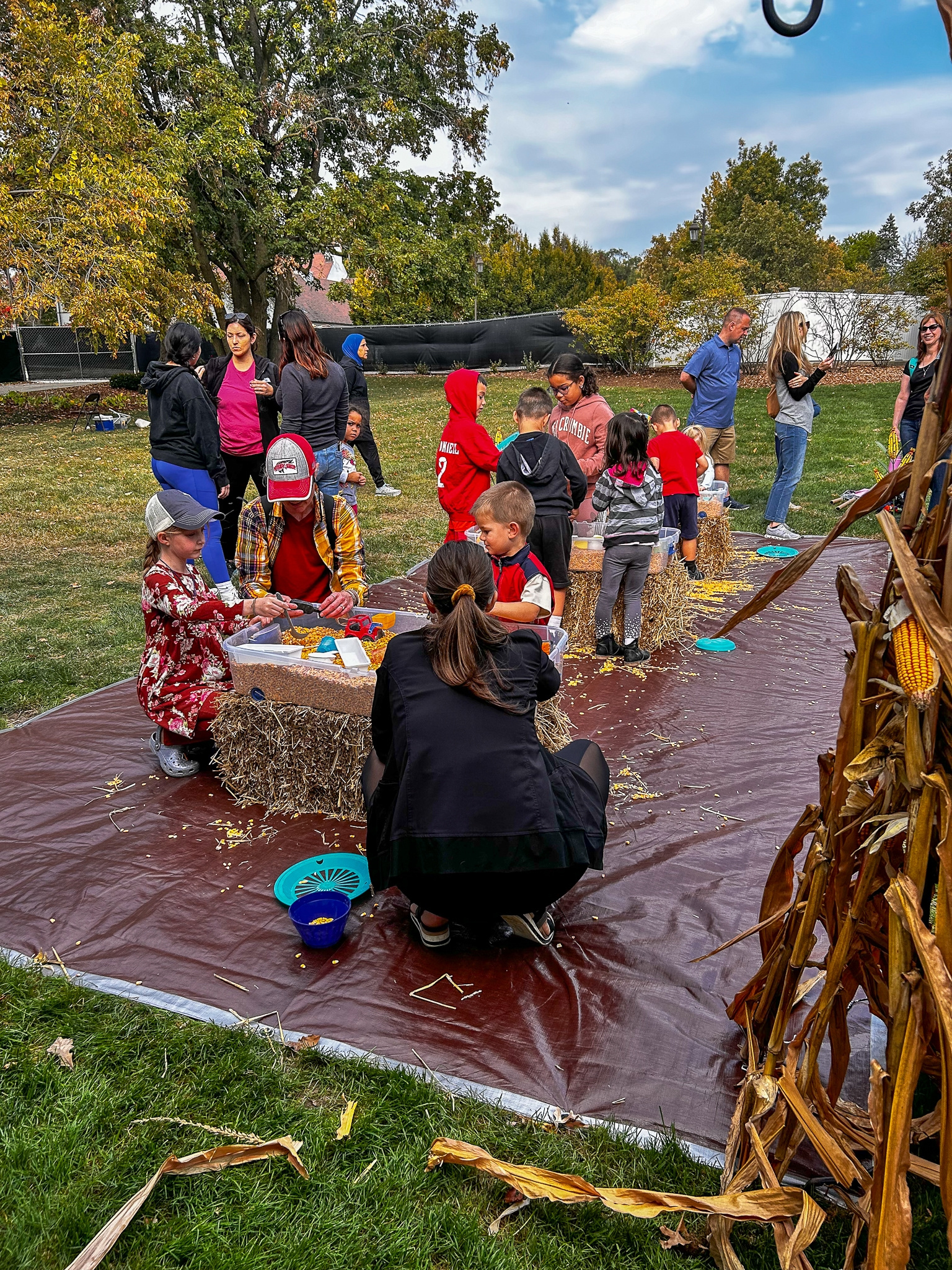 Families and children enjoying a fall activity area at danada